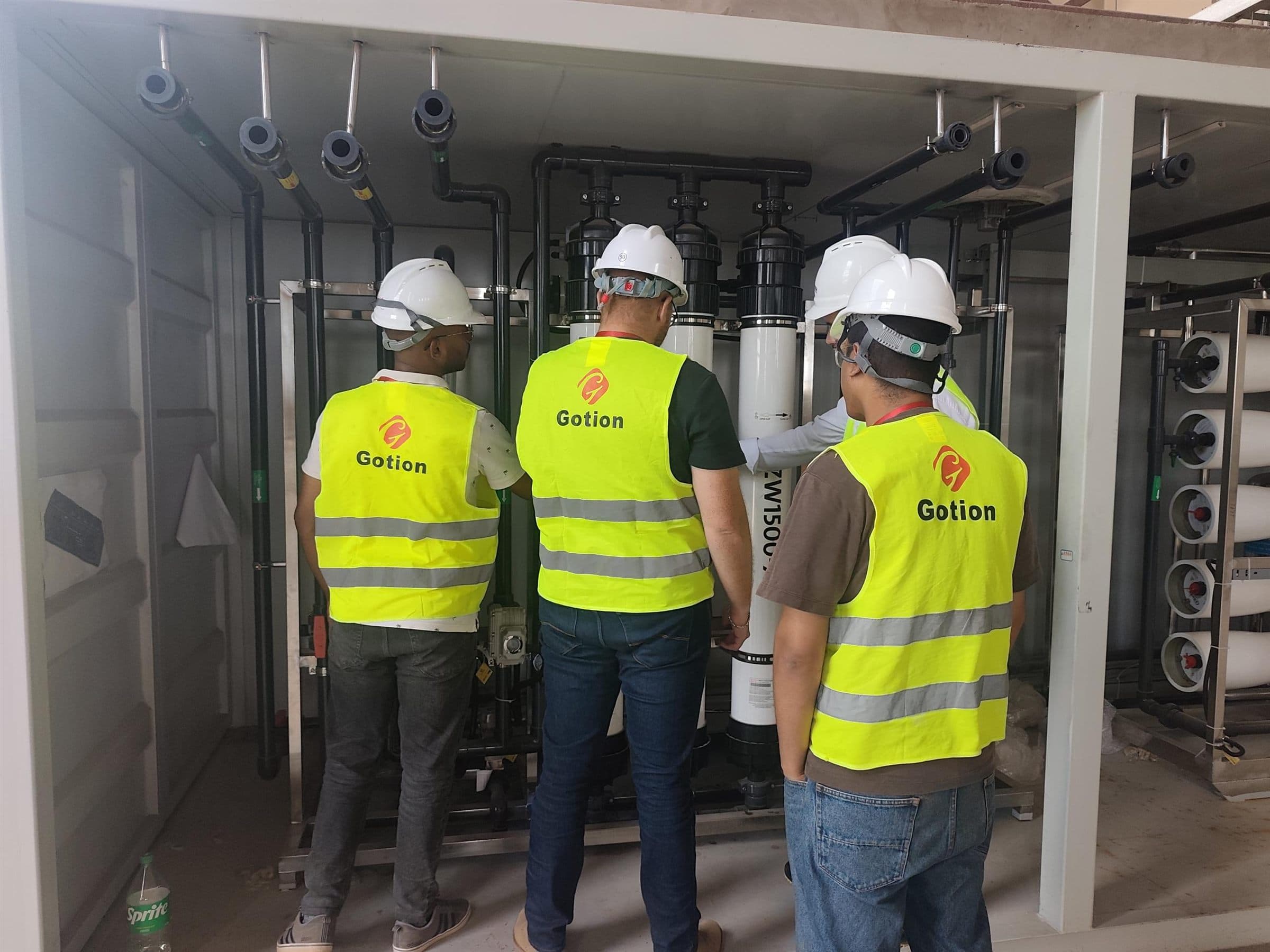 Engineers inspecting a modular industrial pure water system